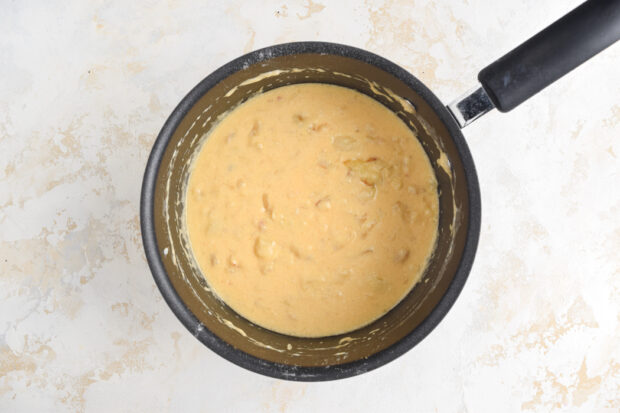 Cheesy onion sauce in a saucepan