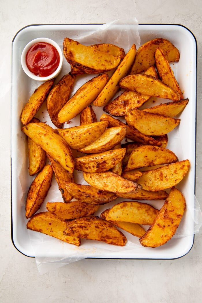 Air fryer potato wedges on a baking sheet