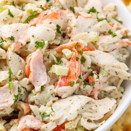 Crab salad in a bowl with an array of saltine crackers