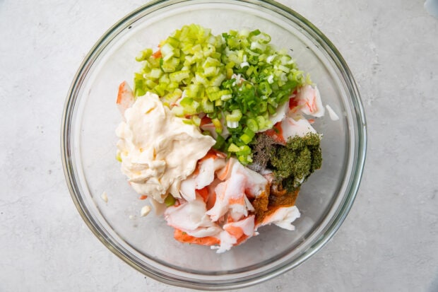 Ingredients for crab salad in a glass mixing bowl