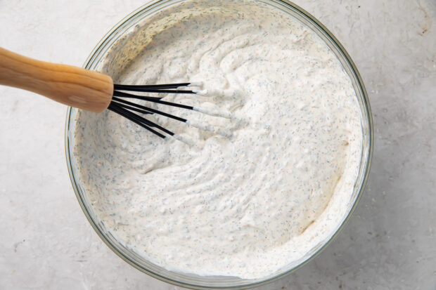 Dill dip in a large glass mixing bowl