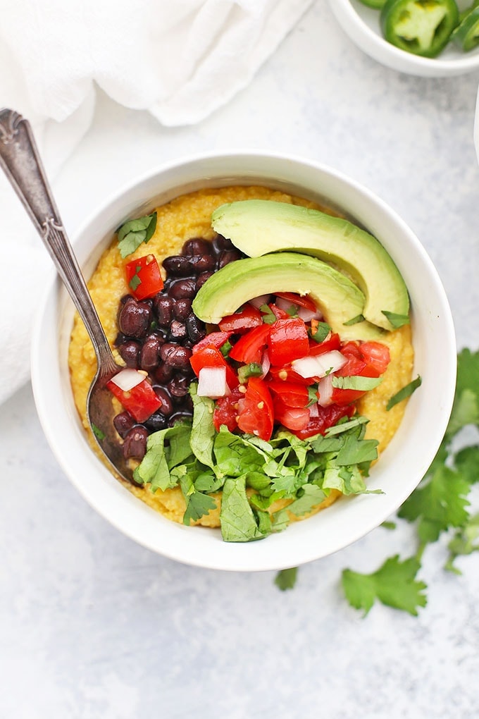 Black bean polenta bowl topped with salsa and avocado