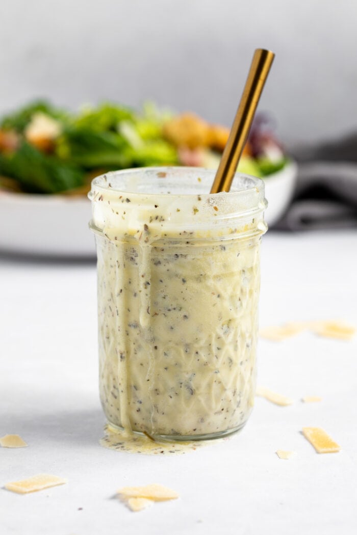 Creamy Italian dressing spilling out a mason jar.