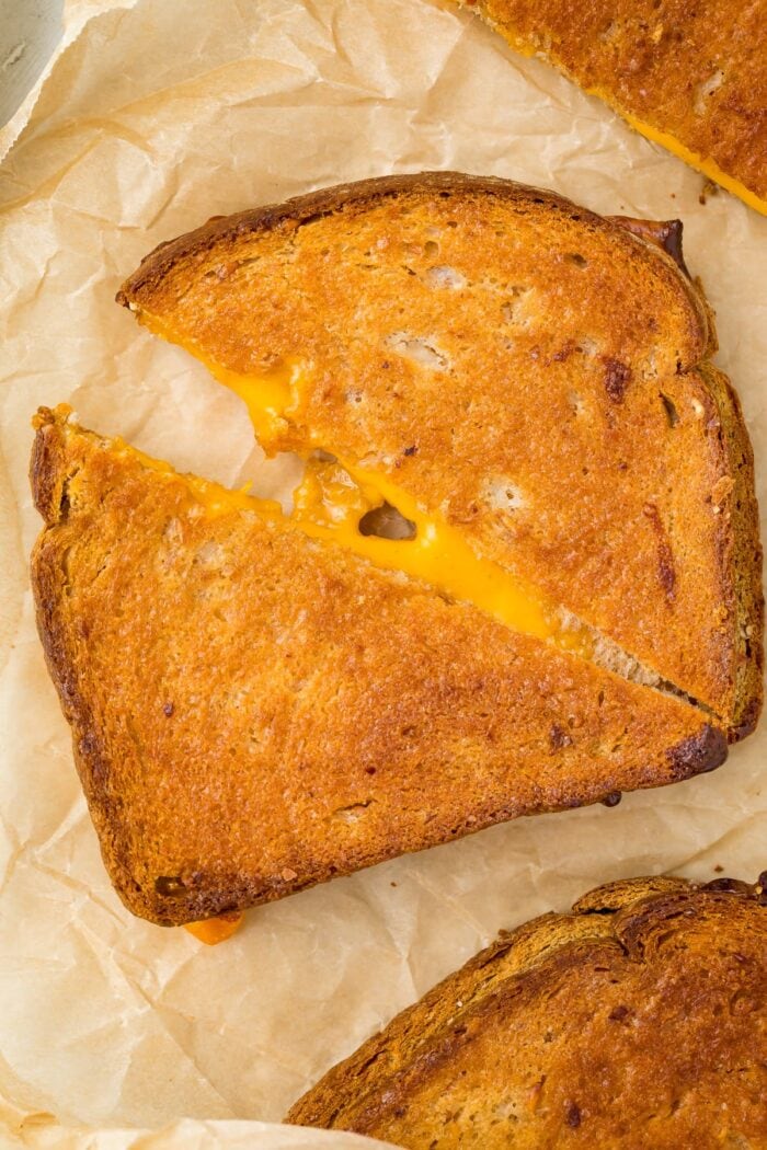 Close up of an air fried grilled cheese sandwich on parchment paper