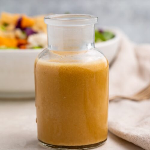 A glass bottle of Asian salad dressing