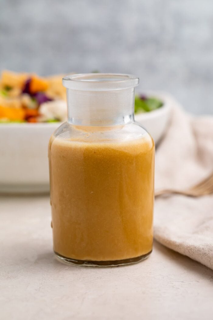 A glass bottle of Asian salad dressing