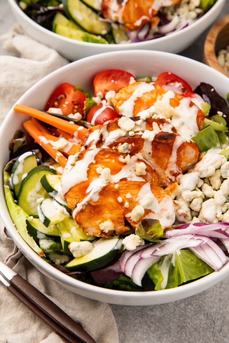 Buffalo chicken salad in a white bowl with ranch dressing