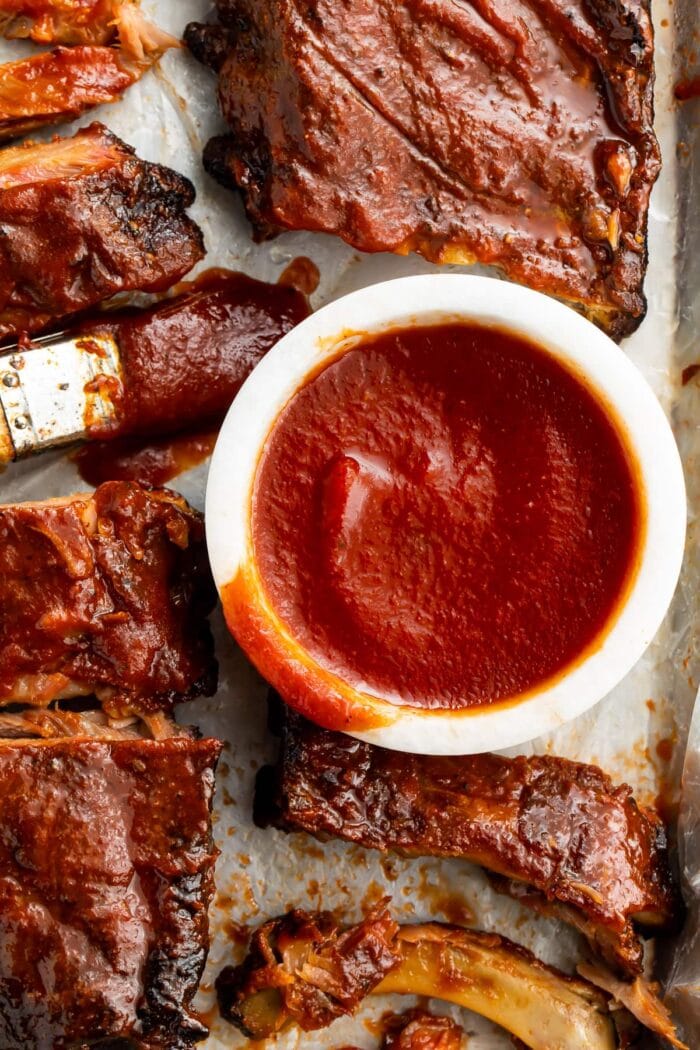 A small bowl of keto bbq sauce surrounded by pulled pork