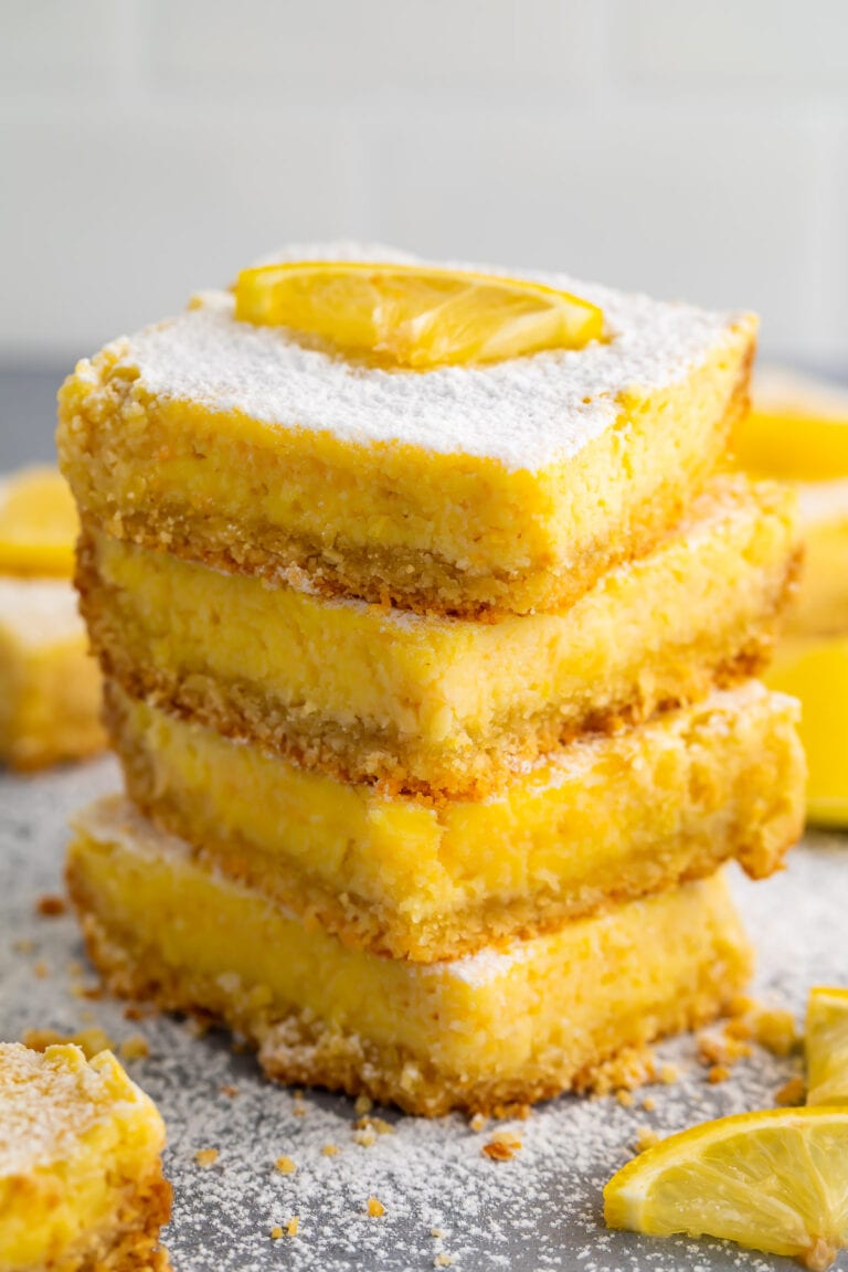 A stack of 4 keto lemon bars against a white background