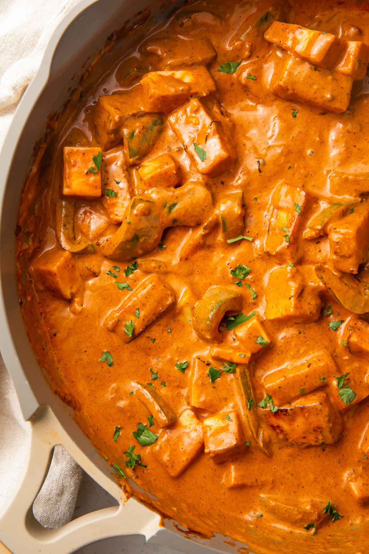 Deep orange paneer tikka masala in a large skillet.