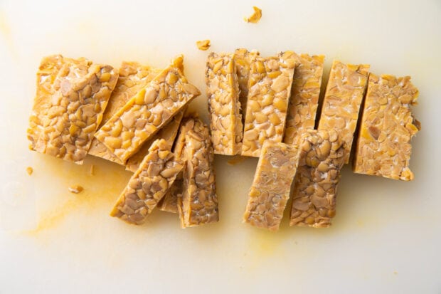 Sliced tempeh on a cutting board