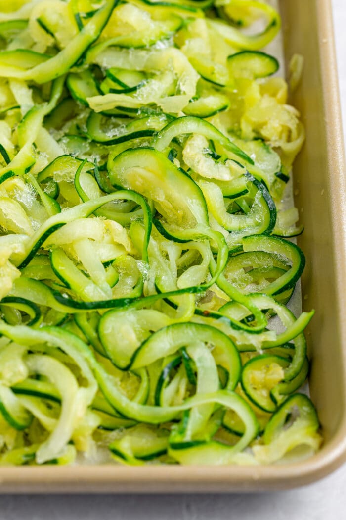 frozen zucchini noodles on a baking sheet