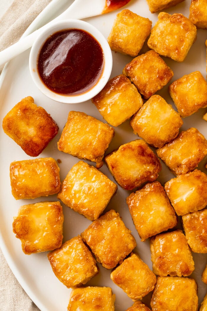 Crispy baked tofu cubes on a white plate