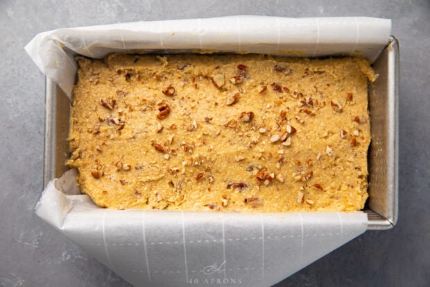 Keto banana bread batter in loaf pan lined with parchment paper