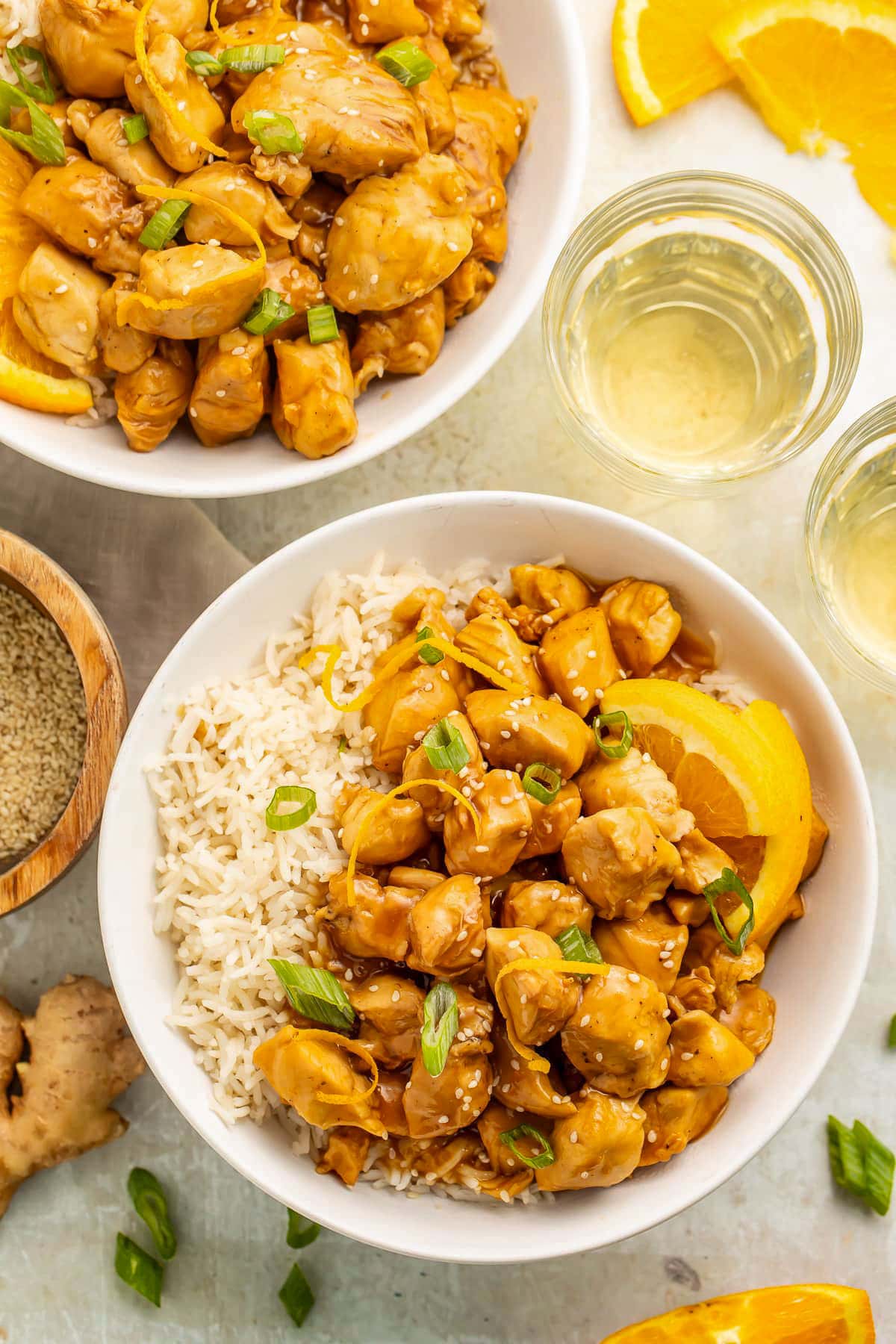 Top-down view of two bowls holding white rice and glazed orange chicken cooked in the Instant Pot.