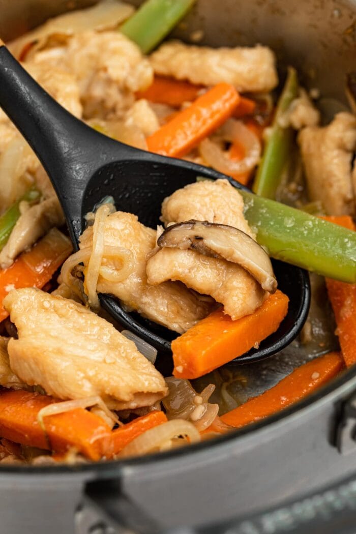 chicken chop suey in a pan with a spoon