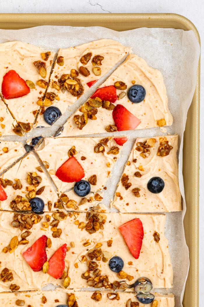 frozen yogurt bark on a baking sheet