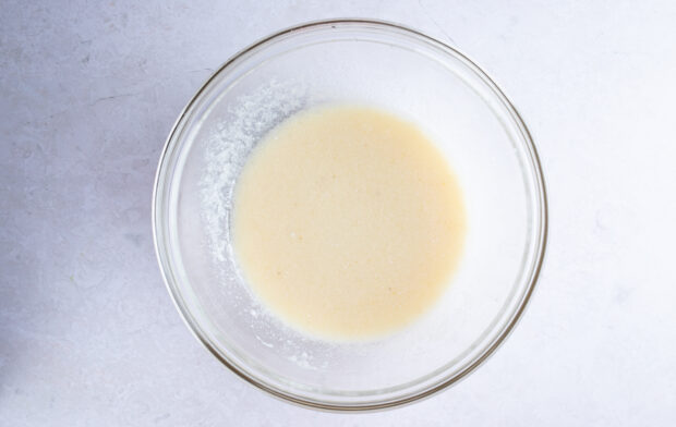 Wet ingredients for gluten free zucchini bread in large glass mixing bowl