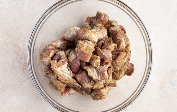 Pork belly in large bowl with dry rub