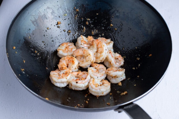 Seasoned shrimp in a large wok