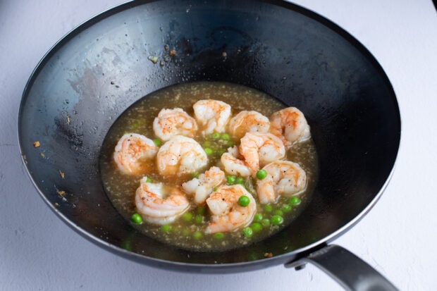 Other ingredients added to large wok with shrimp