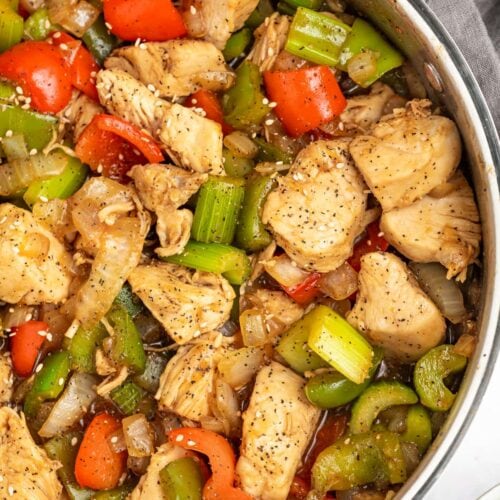 black pepper chicken in a skillet with rice on the side