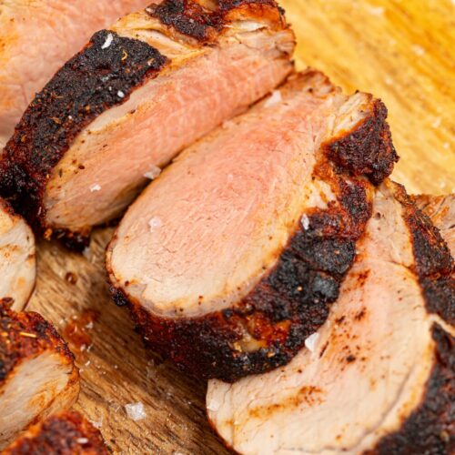 sliced air fryer pork tenderloin on a cutting board