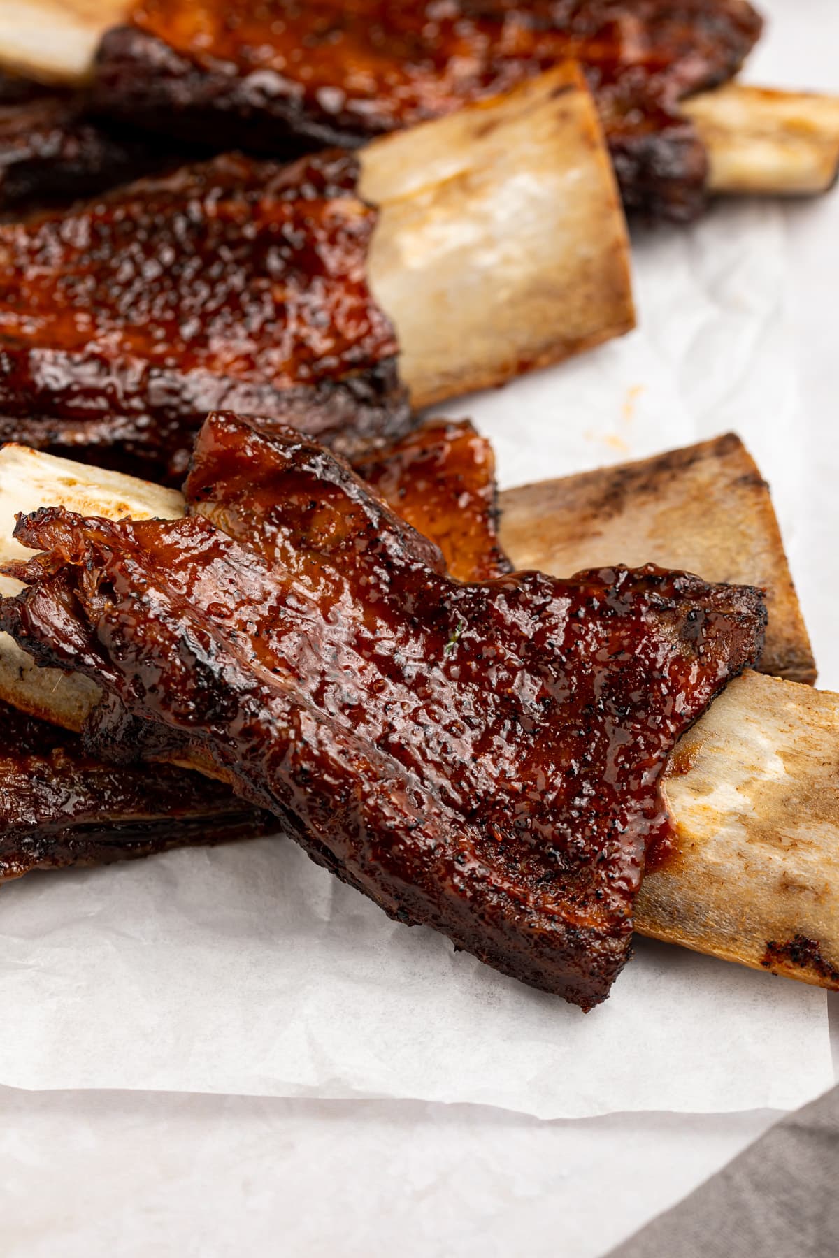 BBQ beef back ribs on a sheet of parchment paper.