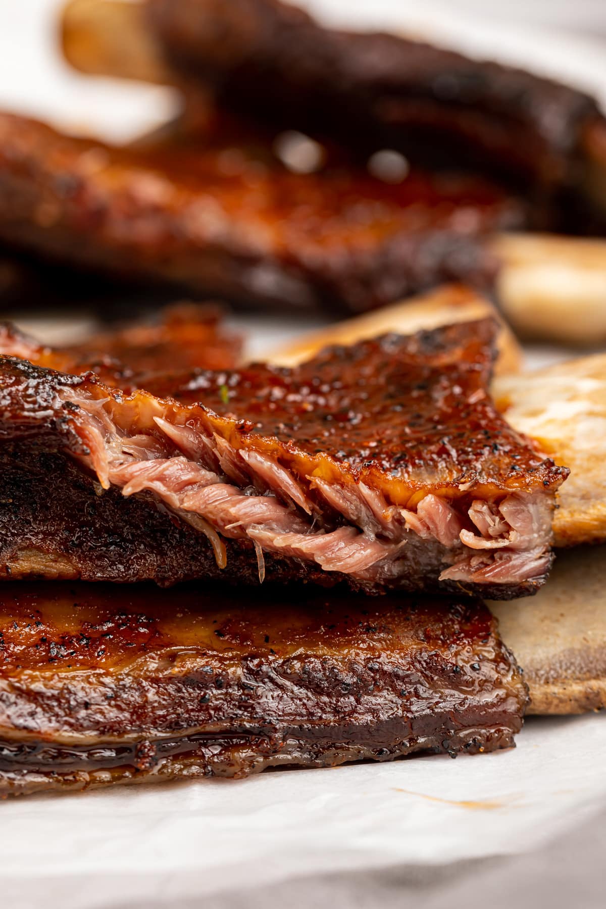 Side view of BBQ beef back ribs showing tender, juicy meat.