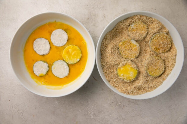 Dip zucchini chips into egg mixture then breadcrumbs to coat