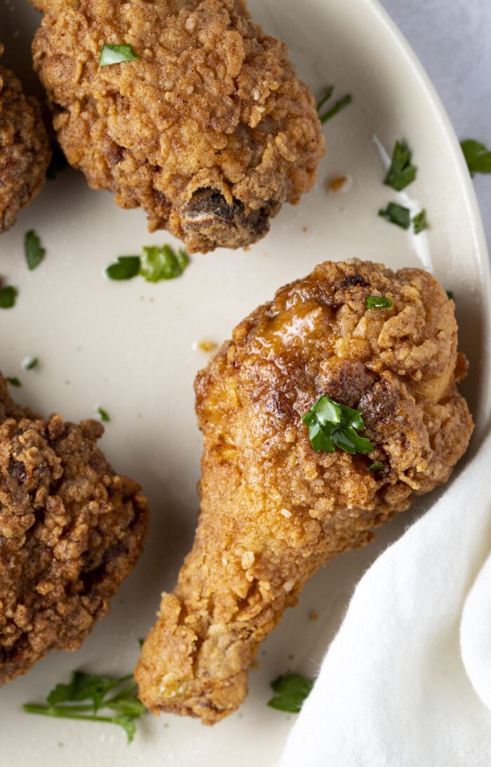 Fried chicken leg on a white plate