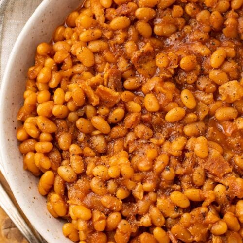 Overhead photo of Instant Pot baked beans in a white bowl on a wooden board