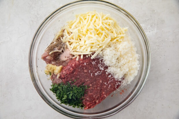 Ingredients for keto meatballs in a large glass bowl