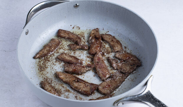 Flank steak in large skillet