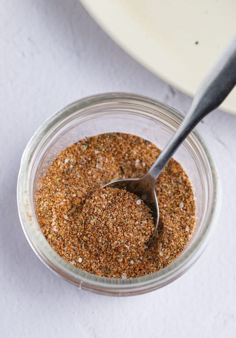 Pork chop seasoning in a small jar with a spoon