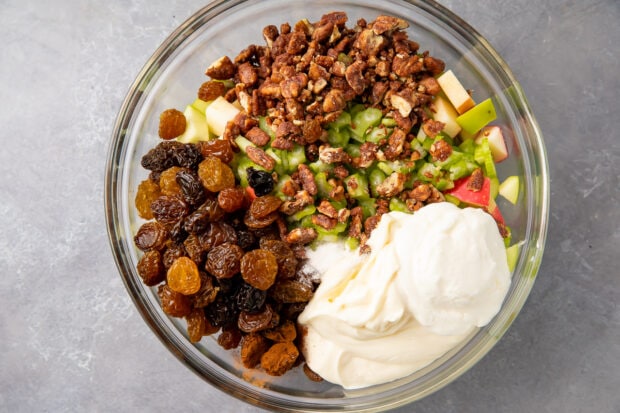 Ingredients for apple salad in large glass mixing bowl