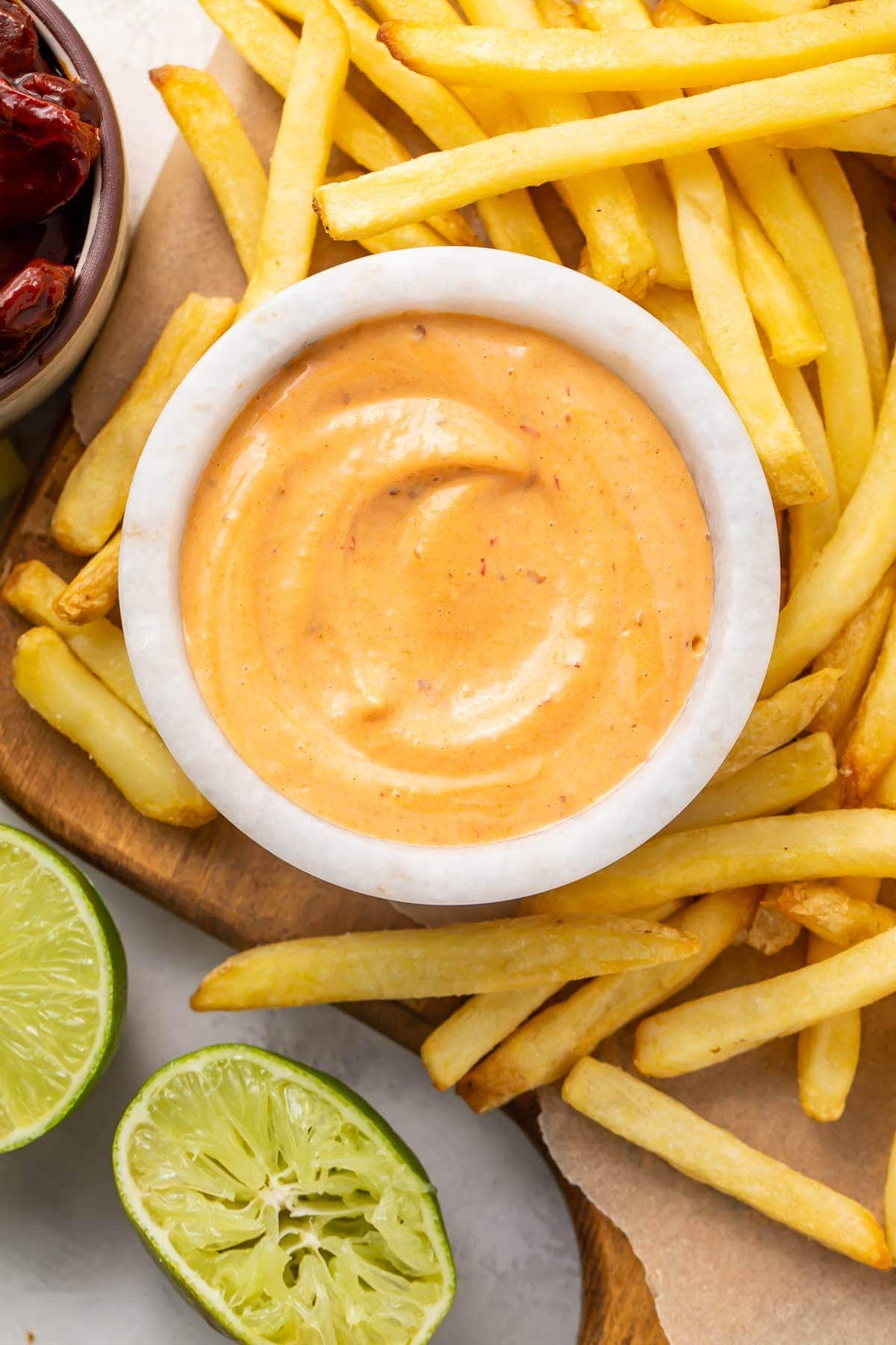 French fries surrounding a small bowl of chipotle mayo