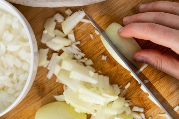 Slice attached side of onion into half inch wide strips