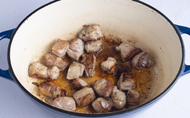 Pork chunks in neutral oil in dutch oven