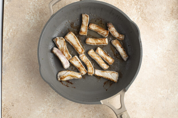 Pork strips in large skillet