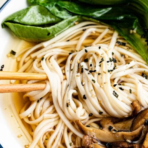 Udon soup in a bowl with blue trim