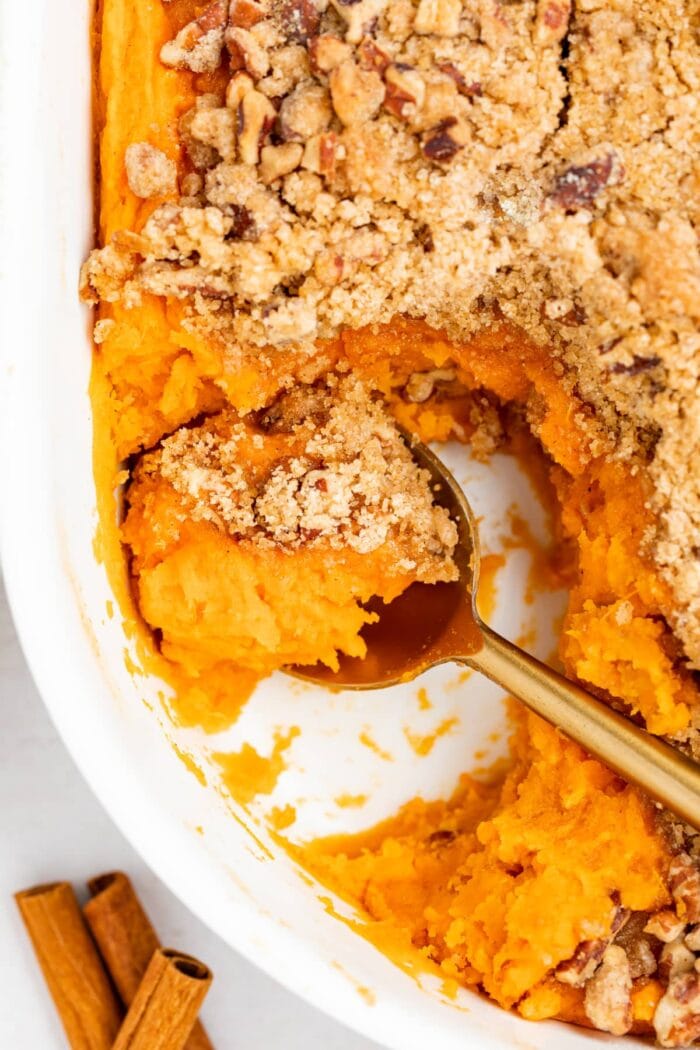 close up overhead image of sweet potato souffle with a spoon in it