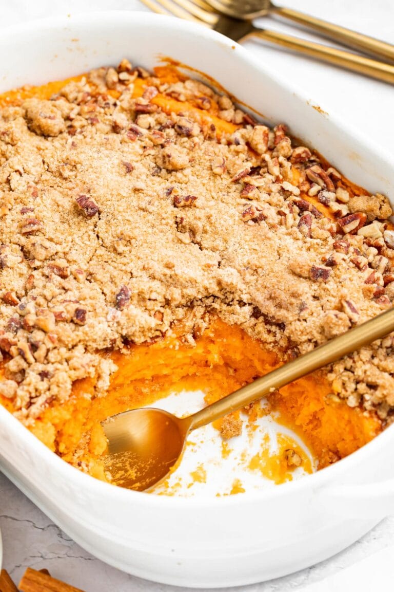 sweet potato souffle in a baking dish with a spoon