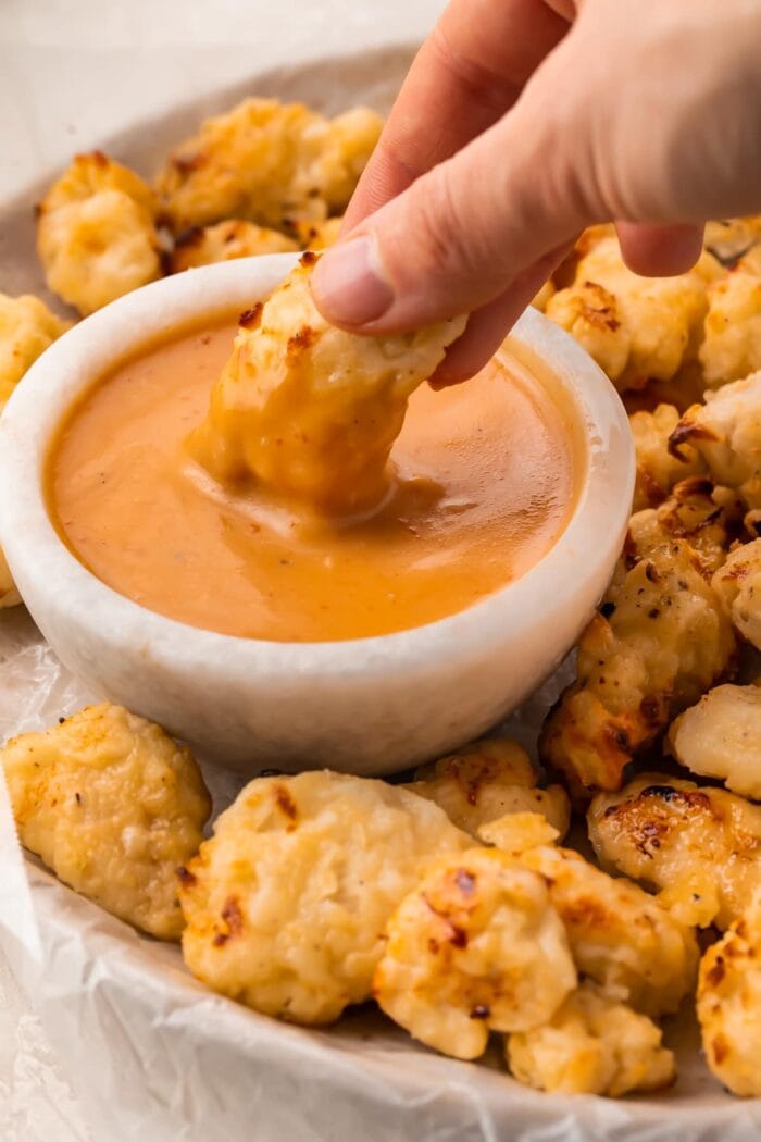 An air fryer chicken nugget dipped into copycat Chick-fil-a sauce