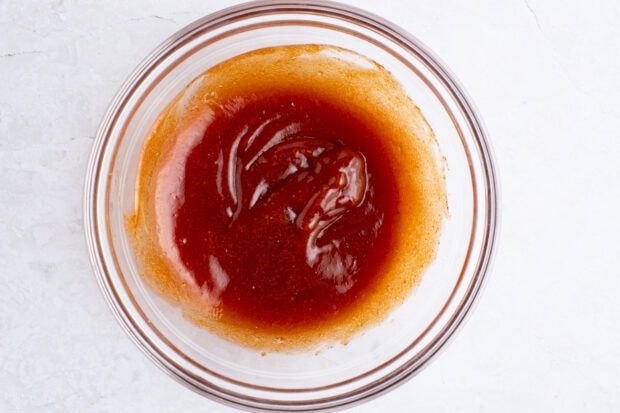 Glaze for bacon wrapped meatloaf in glass mixing bowl