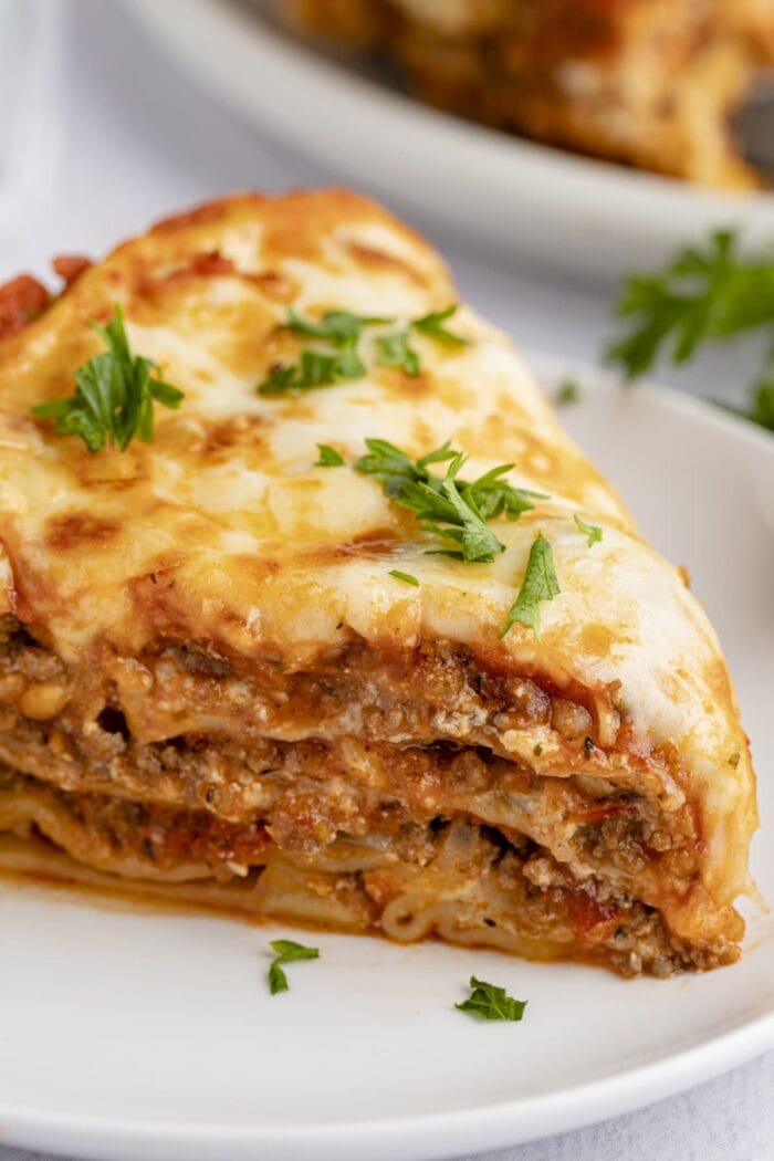 Close up view of a slice of Instant Pot lasagna on a white plate