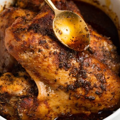 pan drippings being poured over baked turkey wings