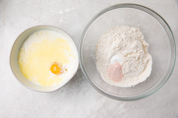 Two bowls, one with dry ingredients and one with ingredients for blini