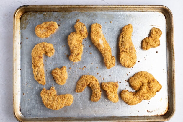 Tyson crispy chicken strips on greased baking sheet