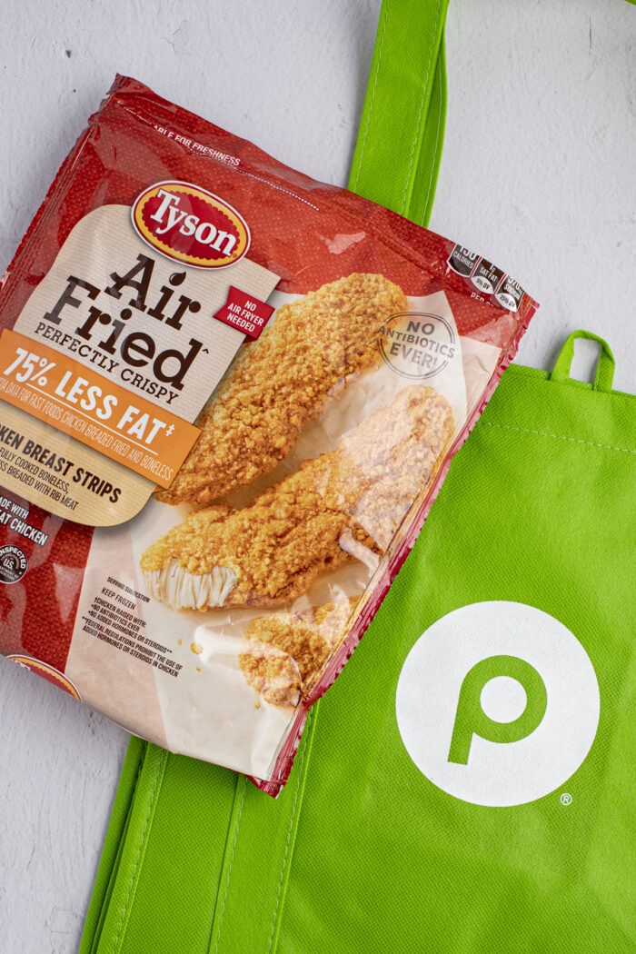 Tyson air fried chicken strips packaging with a Publix reusable shopping bag